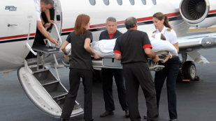 Medical personnel accompany an air ambulance flight